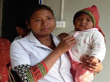 Tipini Clinic nurse midwife with child